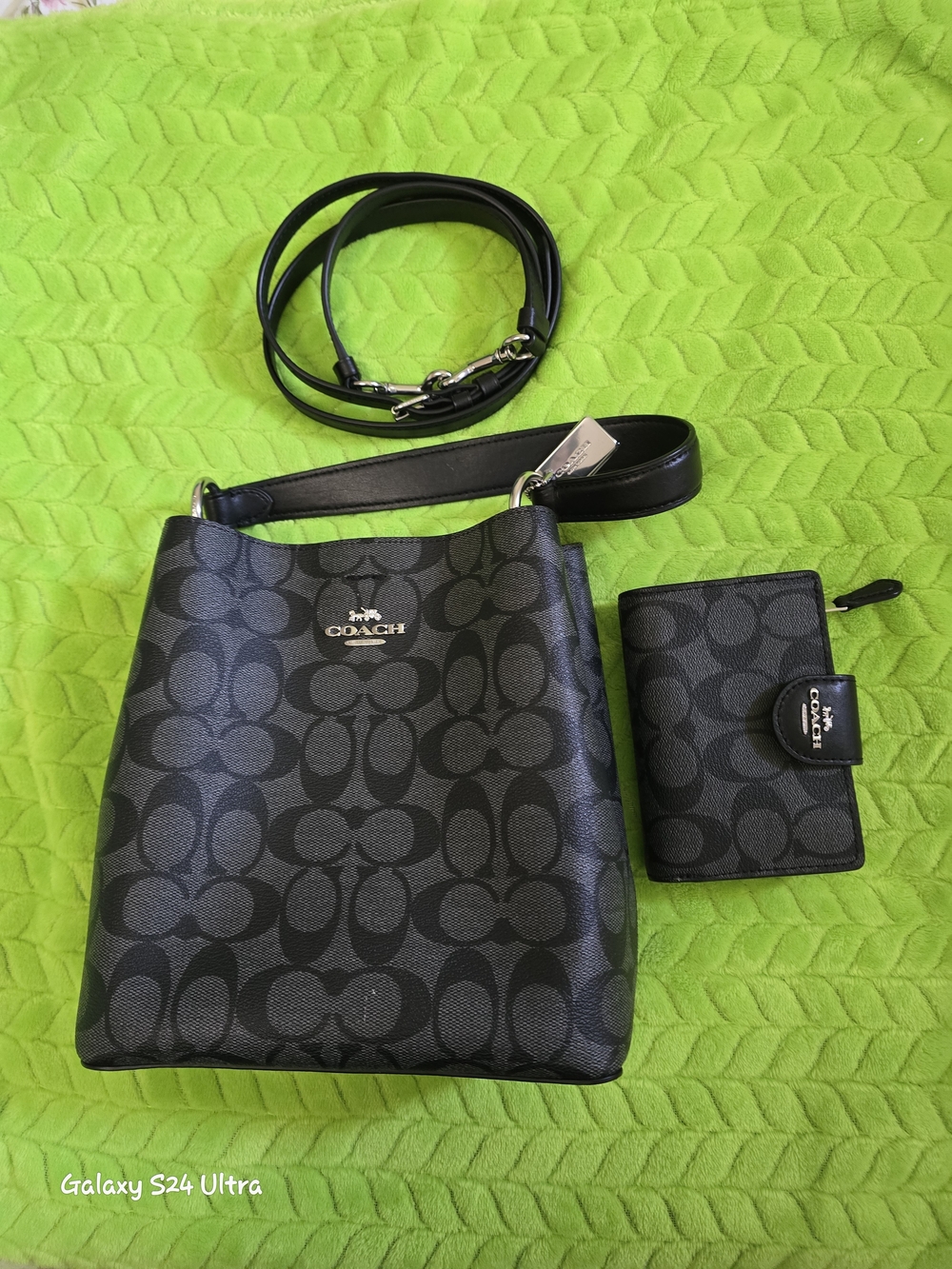 Coach Black Signature Small Shoulder Bag with the matching wallet.